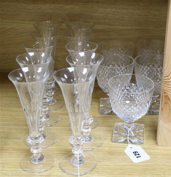 A set of twelve William Yeoward panel-cut champagne flutes and five heavy cut-glass goblets